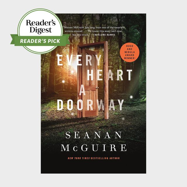 A wooden door stands open in a sunlit forest, surrounded by trees. Text reads, 