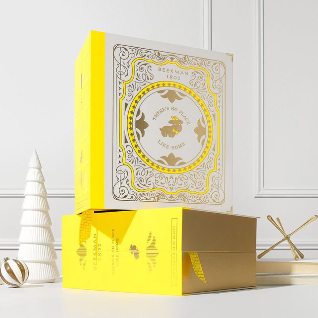 Boxes stacked neatly, displaying intricate golden designs and text that reads 