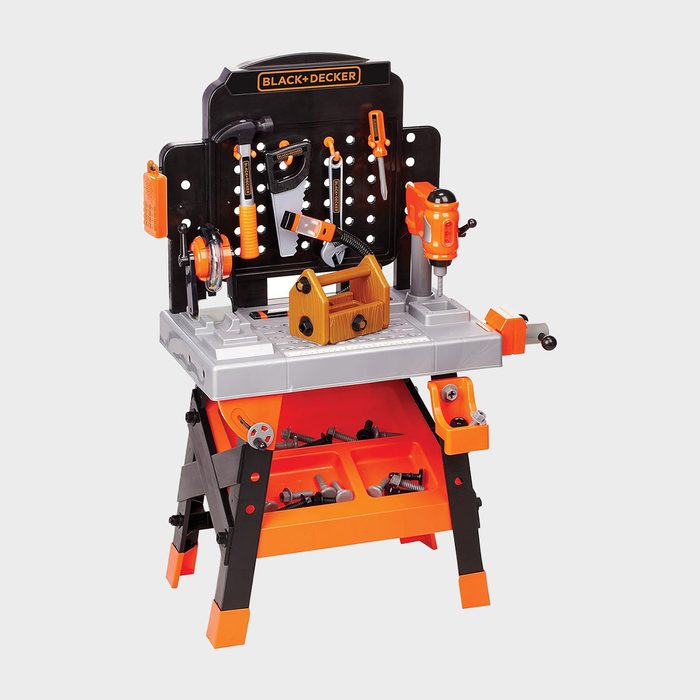 Toy workbench with tools hanging, organized neatly. Set against a simple background, it features a saw, hammer, drill, and storage section.
