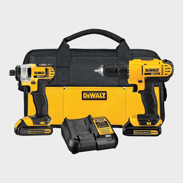 Two yellow power drills rest on a black and yellow bag, accompanied by a battery charger, all branded with 