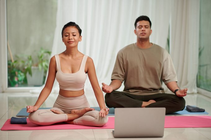 Couple Practising Yoga Breath Exercise