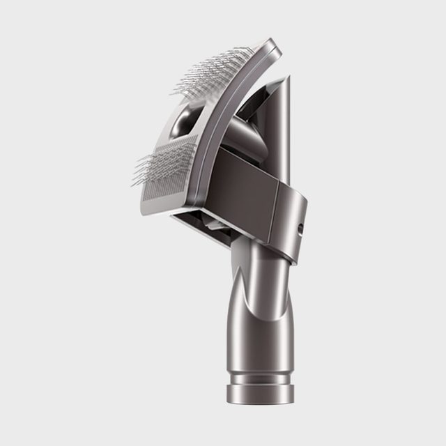 Metal grooming attachment displays bristles, connected to a cylindrical base, set against a plain white background.