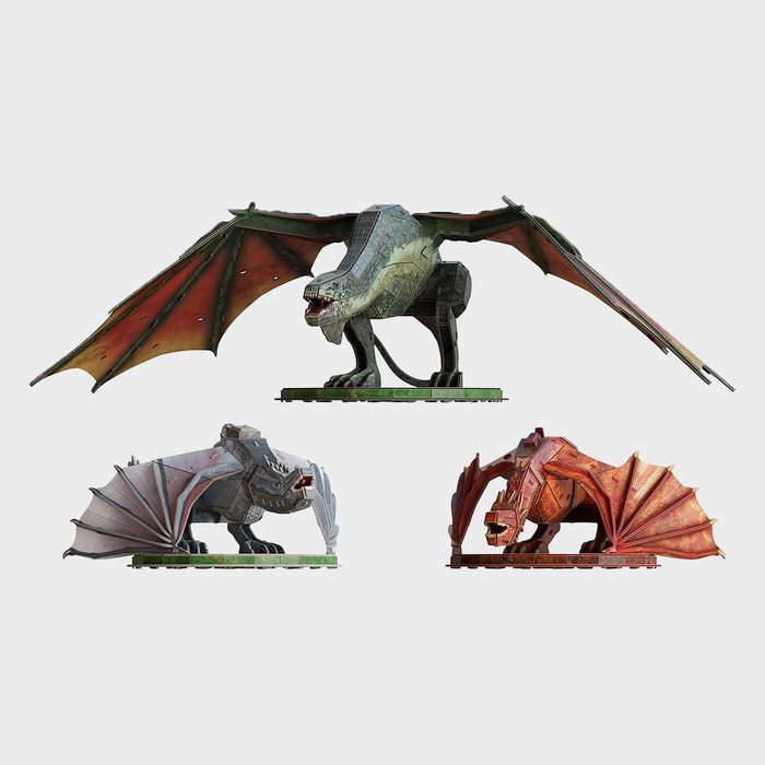 Three mechanical dragon models display varying poses, with wings extended, on a plain white background.
