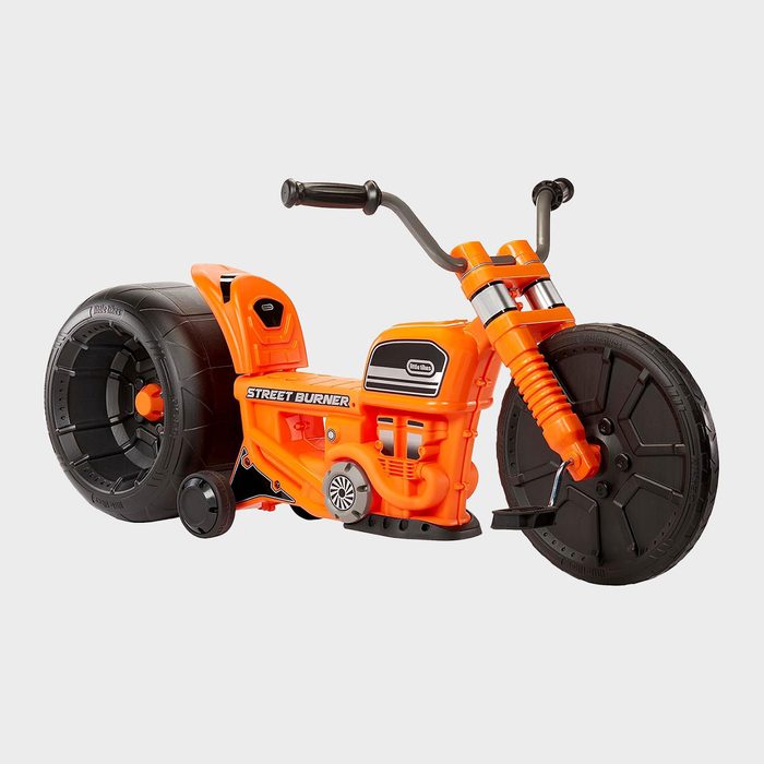 Orange toy motorcycle stands stationary, featuring large wheels and 