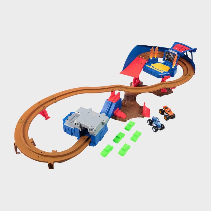 Toy track, looped with ramps, features two monster trucks and six green ramps on a grey background.