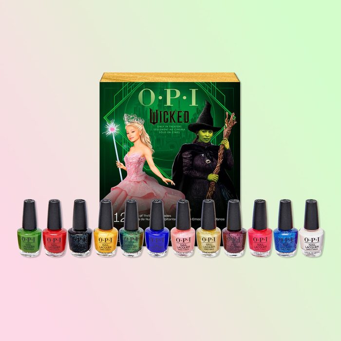Nail polish bottles are lined up in front of an OPI 