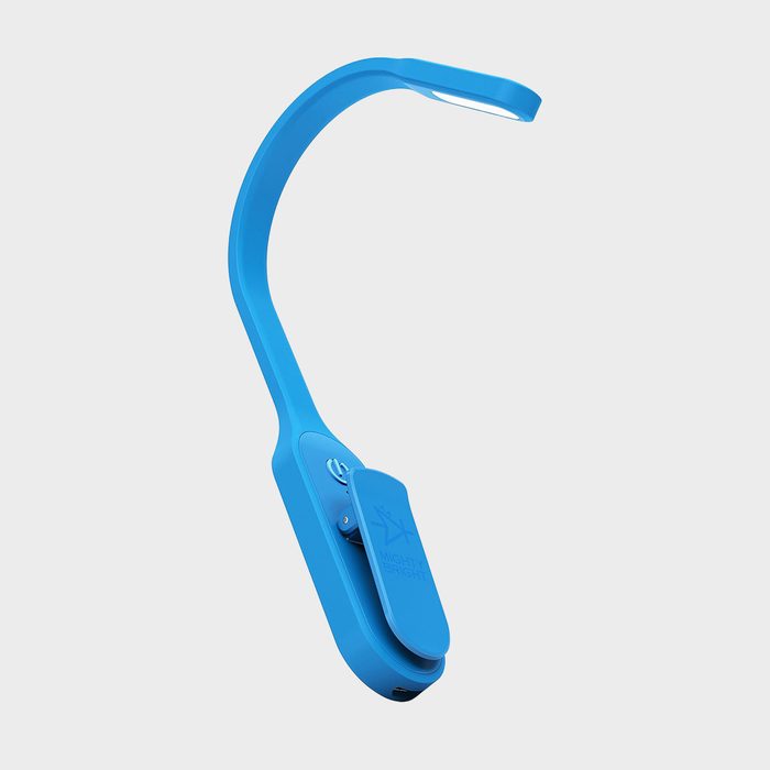 A blue clip-on LED reading light with a curved neck, powered on, set against a plain light gray background.