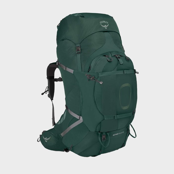 Green backpack stands upright with multiple compartments, straps, and 