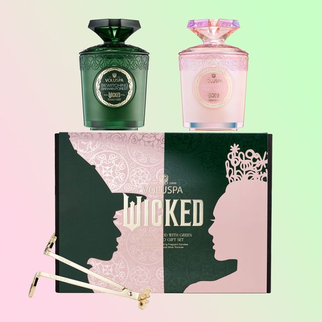 Candles rest atop a decorative box featuring silhouetted profiles. Gold wick trimmers lie nearby. Text: 