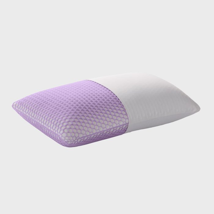 Pillow covered in textured purple and smooth white fabric, resting on a plain surface.
