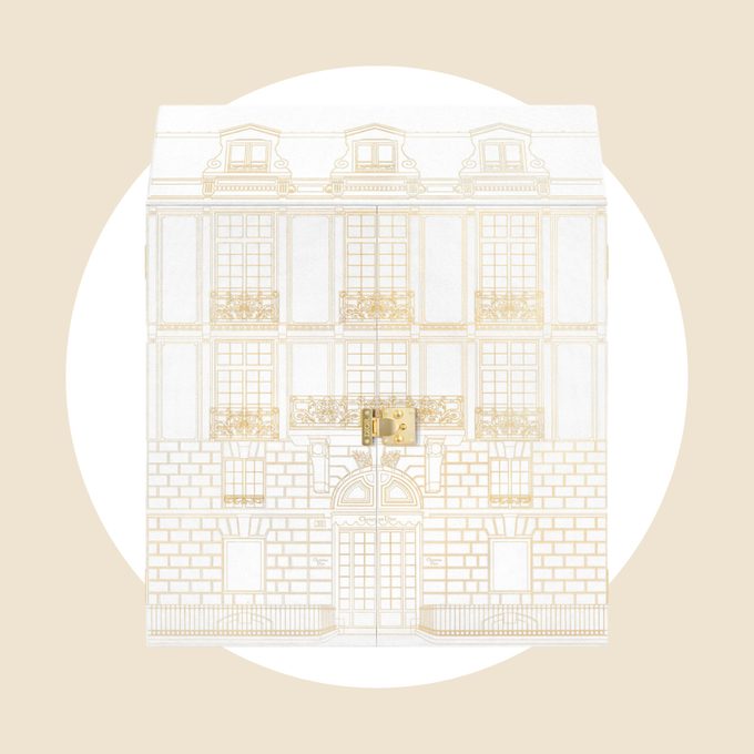 An illustrated box resembles a grand building, featuring detailed architectural designs, against a plain beige background.