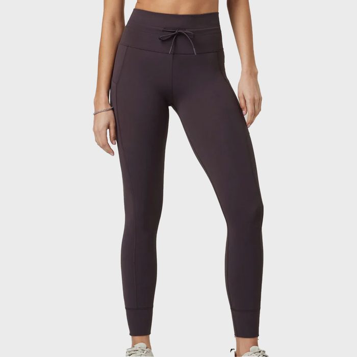 Black leggings are worn by a person, standing relaxed, on a white background.