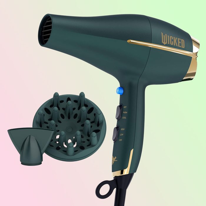 A green hair dryer with attachments displayed, labeled 