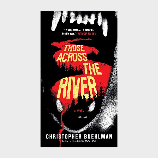 Teeth hover menacingly, framing blood-red forest silhouette with yellow text: &acirc;&euro;&oelig;Those Across the River.&acirc;&euro; Dark, ominous atmosphere. Author: Christopher Buehlman.