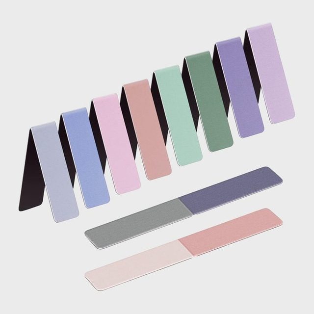 Colorful, rectangular magnetic bookmarks lie folded and unfolded on a plain white background, displayed in an array of pastel shades.