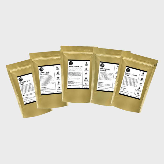 Five gold foil bags display tea labels with names like 