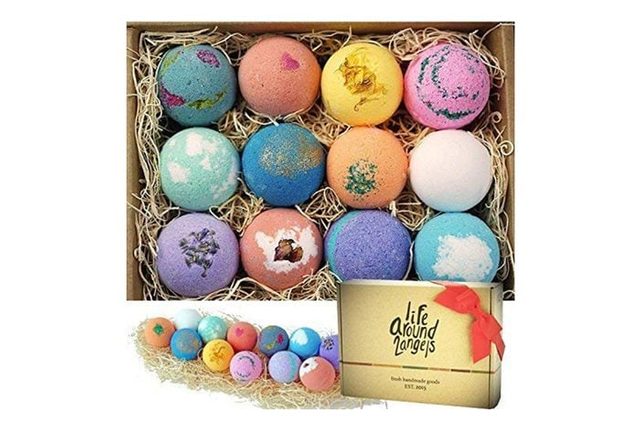 Colorful bath bombs rest in a straw-filled box; additional set displayed below alongside a gift box labeled 