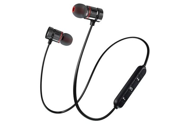 Black wireless earphones have a connecting wire with an in-line control panel, featuring buttons, set against a plain white background.