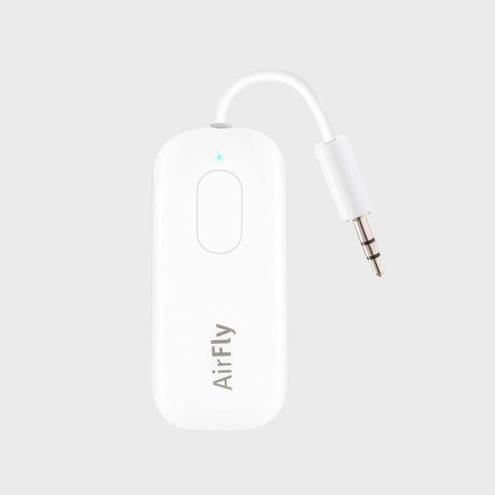 A white wireless adapter with a cable and plug labeled 