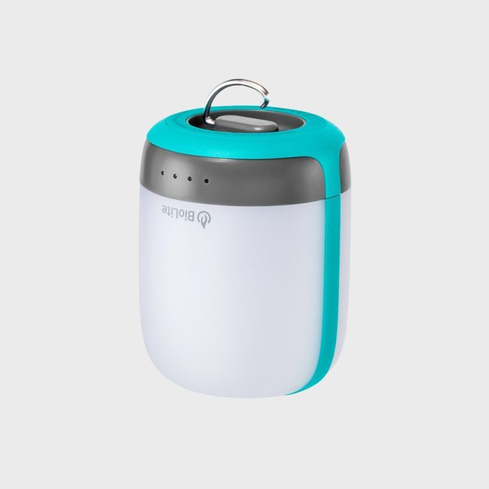 Lantern stands upright; features a teal top with a handle and white base. Logo 