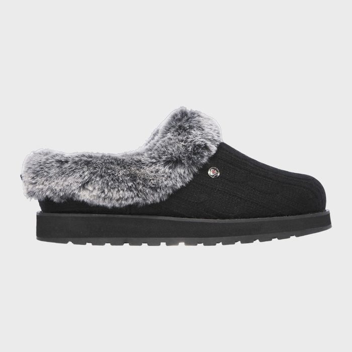Black slipper featuring faux fur trim, positioned laterally against a plain background.