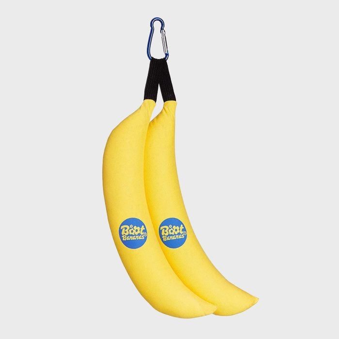 Two yellow banana-shaped objects hang with a carabiner in a plain gray background; each has a blue 