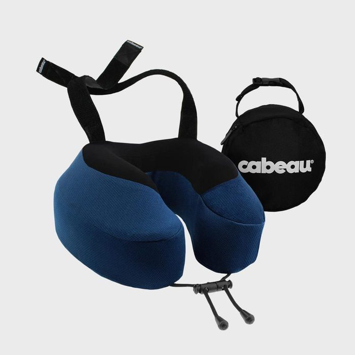 Neck pillow sits suspended, featuring a blue and black design, accompanied by a round travel bag labeled 