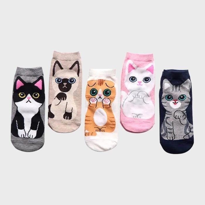 Socks depicting cartoon cats stand upright against a plain background.