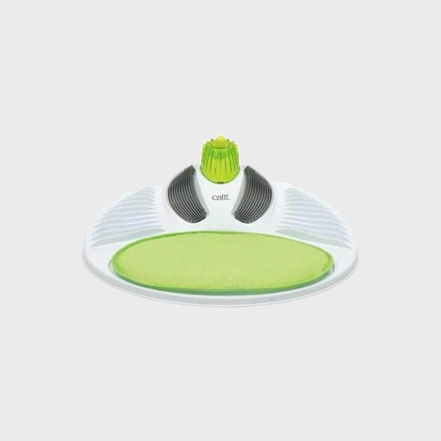 Device sits idle with green textured pad, black ridges, surrounded by white plastic.