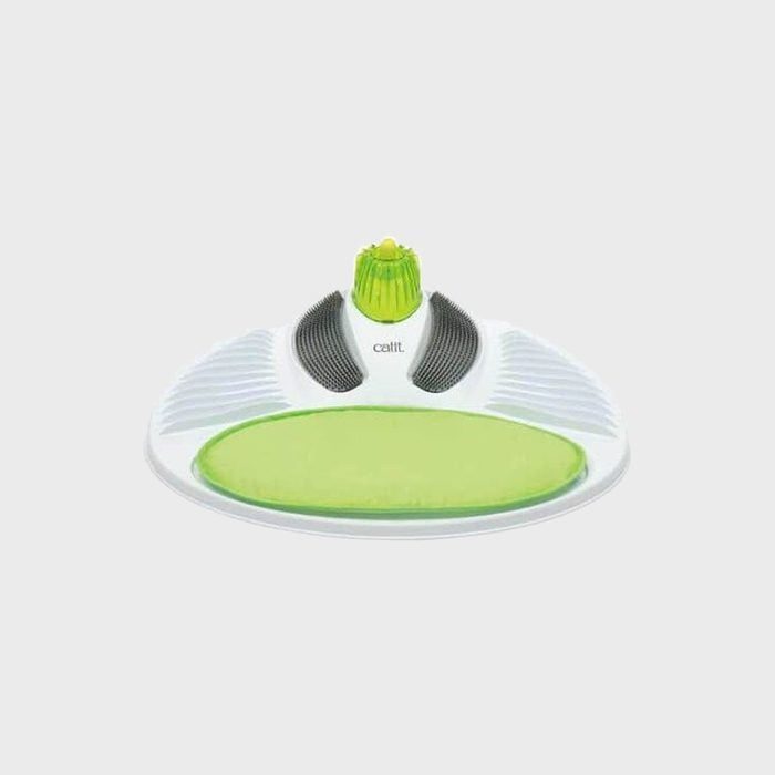 Device sits idle with green textured pad, black ridges, surrounded by white plastic.