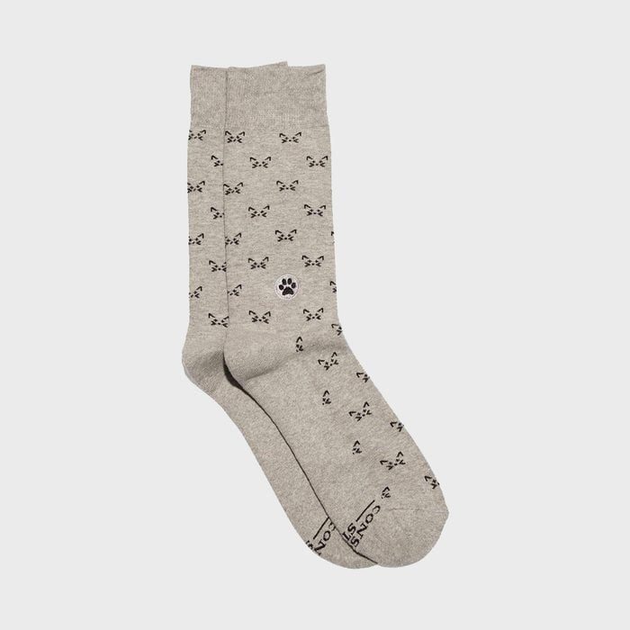Gray socks display black cat faces and a paw print pattern. 