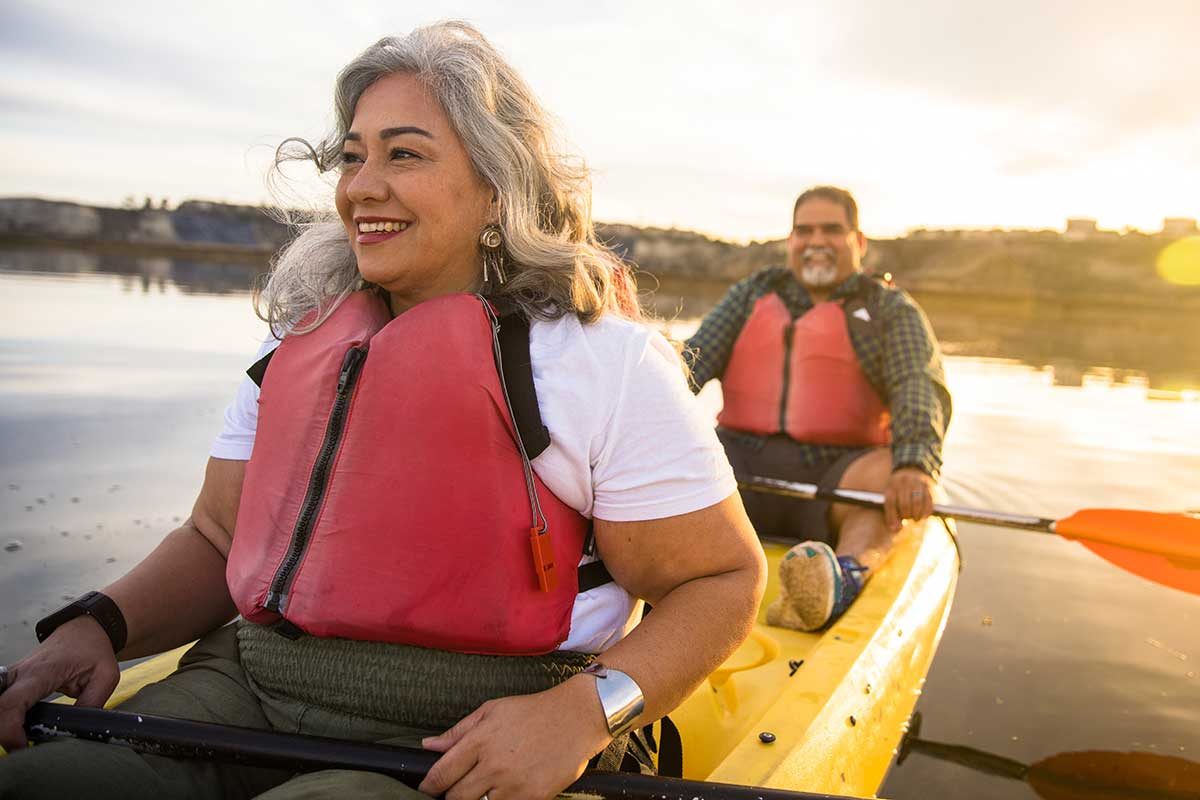 Couple kayaking along river.