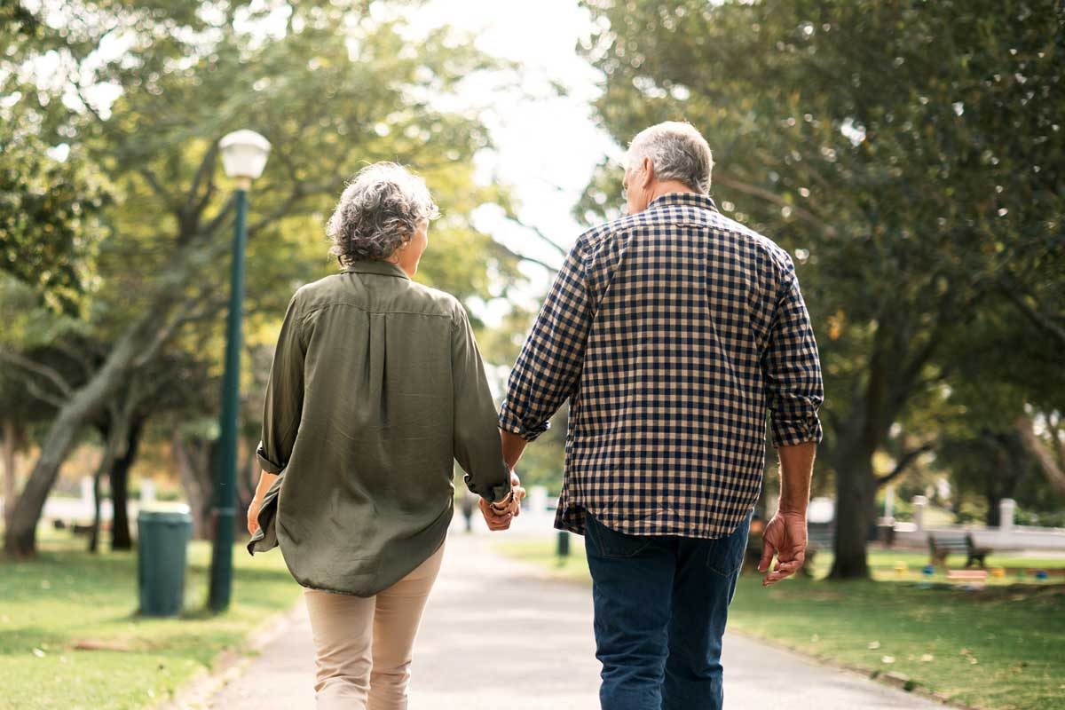 Couple walking in park.