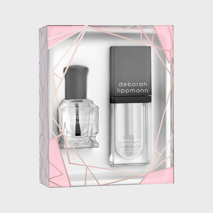 Nail polish and lip gloss displayed in a geometric-designed box with pink accents; labeled 