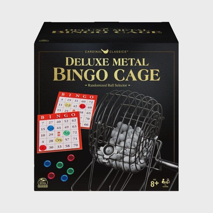 Bingo cage rotates, holding numbered balls, with bingo cards displayed, set against a black box labeled 