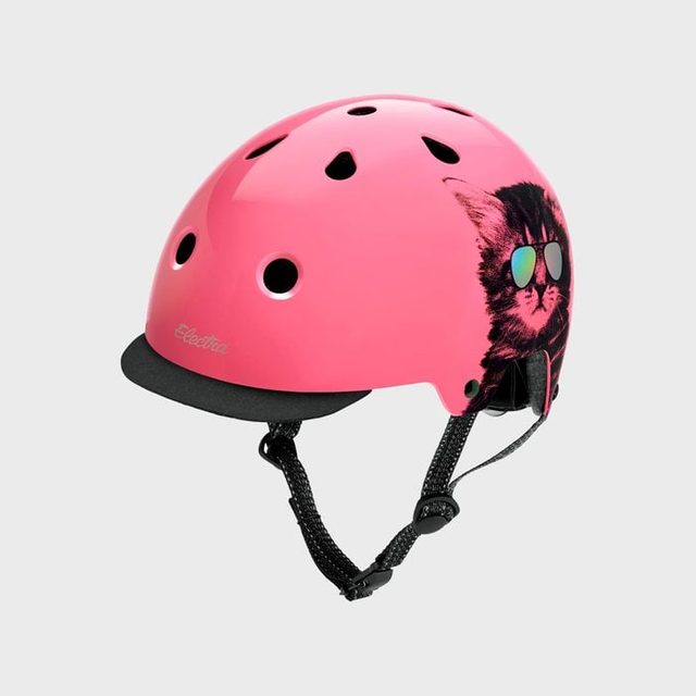 Pink helmet featuring a cool cat with sunglasses, resting against a plain gray background.