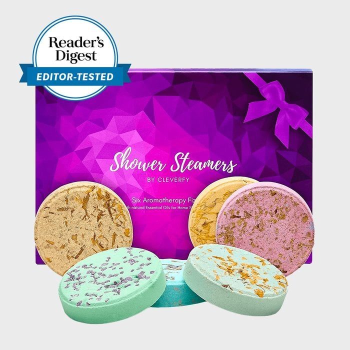 Round shower steamers sit before a purple box labeled â€œShower Steamers by Cleverfy.â€ A â€œReaderâ€™s Digest Editor-Testedâ€ badge is on the box.
