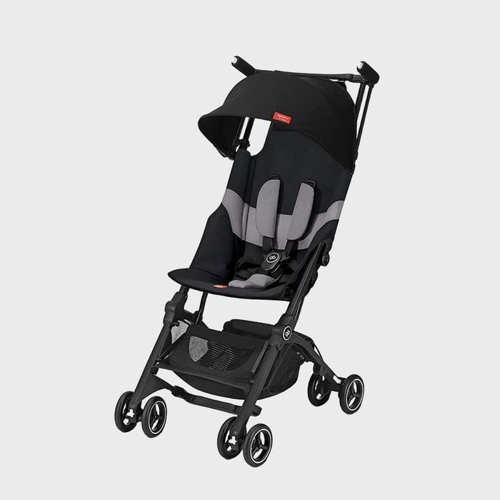 Stroller stands stationary, featuring a reclining seat and canopy, with multiple wheels and black-gray color; situated against a plain background.
