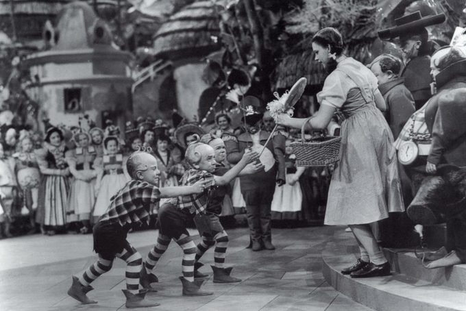 Jerry Maren, playing a Lollipop Guild Member, presents Judy Garland with a lollipop in the film "The Wizard of Oz."