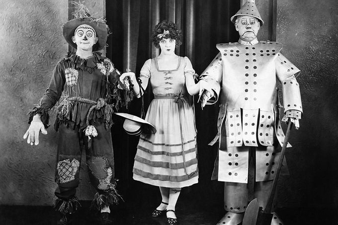 Cast members of the 1925 silent film version of The Wizard of Oz in costume (from left): Larry Semon as the Scarecrow, Dorothy Dwan as Dorothy, and Oliver Hardy as the Tin Woodsman.