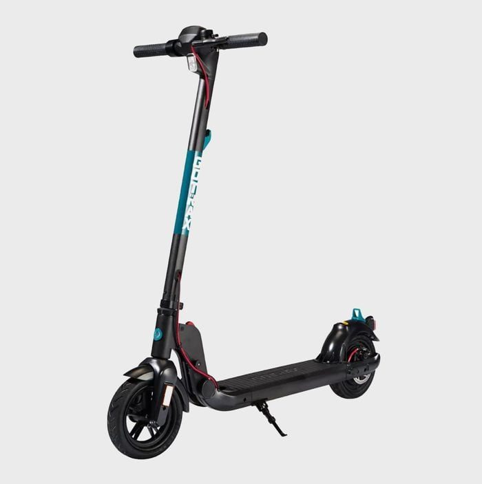Electric scooter stands upright, showing handlebars and deck with 