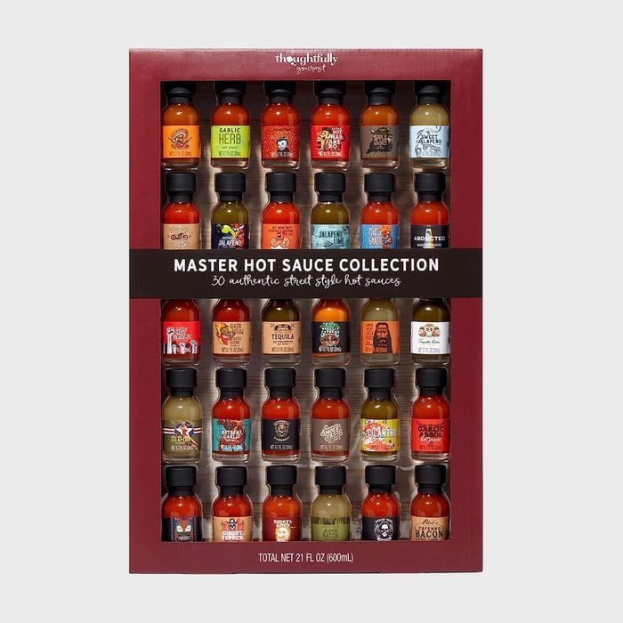 Bottles arranged; showcasing diverse hot sauces; in a boxed collection labeled 