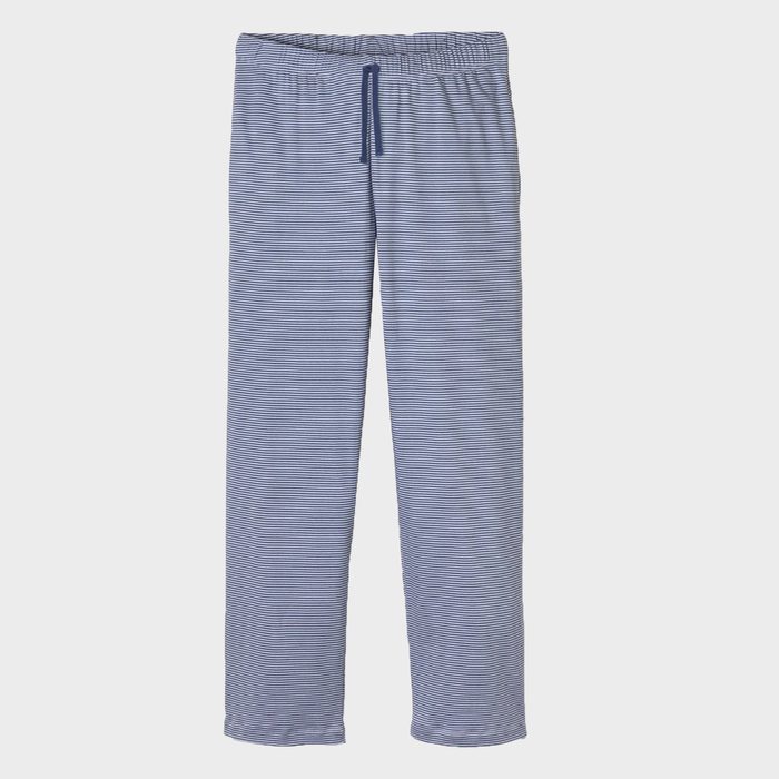 Striped pajama pants hang against a plain white background, featuring a drawstring waistband.