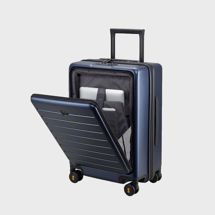Suitcase opens to reveal laptop storage; positioned upright with extended handle, features four wheels; set against a plain gray background.