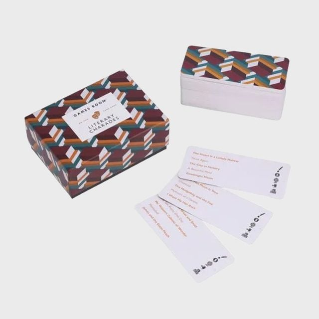 Box and cards display literary charades game, featuring colorful geometric patterns; cards list various book-related prompts on a neutral background.