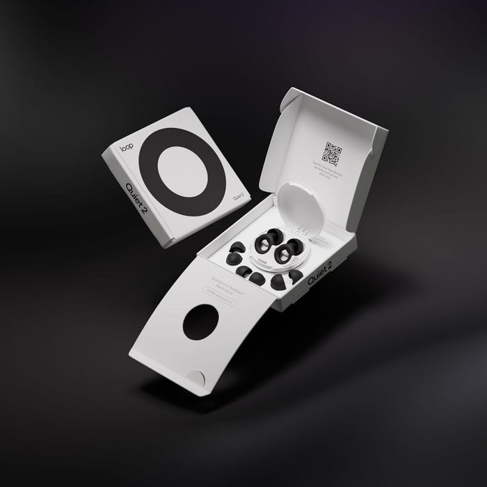 Earplugs rest inside an open white box, surrounded by black inserts; packaging reads 