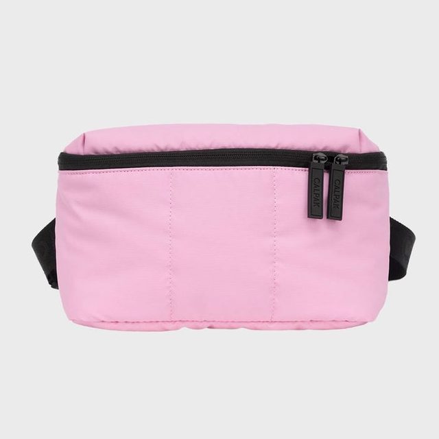 Pink waist bag displays zippers, showcasing black pulls reading 