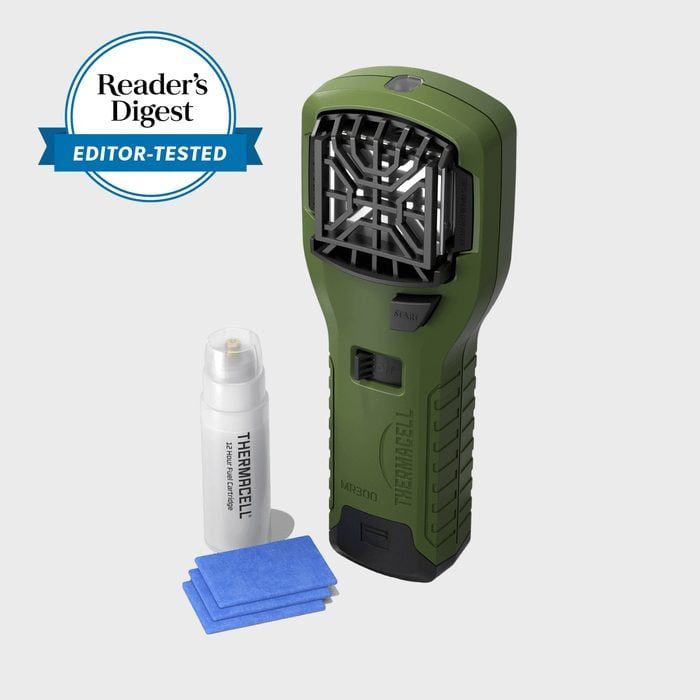Device rests next to spray and blue squares; green handheld mosquito repeller, labeled 