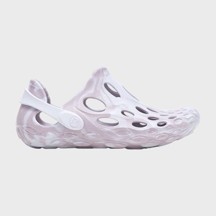 A slip-on sandal with circular cutouts and a marbled pink and white pattern, set against a plain gray background.