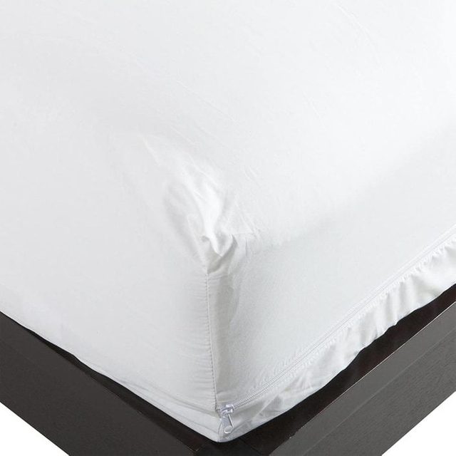 Mattress cover fits over a corner, secured with a zipper, on a dark bed frame.